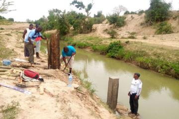 Kenya Water Resources Management Authority workers build a water quality monitoring station on the Mwache River.Photo courtesy of the Mwache Dam Project