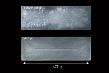 Solidified cross-sections from aluminum ingots were made using a conventional method (top) and a new jet metal process developed by MIT researchers. “The introduction of the jet induced a completely different recirculation of the grains, an...