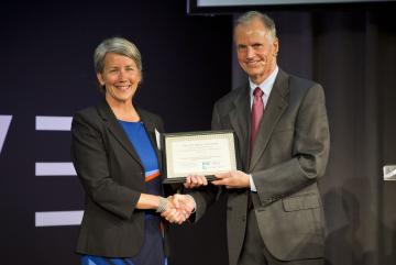 Elizabeth Sheehan, CEO of Climate Smart, receives the $10,000 grand prize from MIT professor and Climate CoLab founder Thomas Malone.