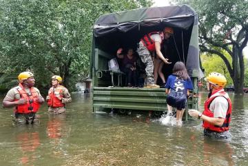 Texas Army National Guardsmen help Houston residents affected by flooding caused by Hurricane Harvey board a military vehicle. "With an event like this," says MIT associate professor of urban planning Brent Ryan, "it becomes viscerally evident whic...