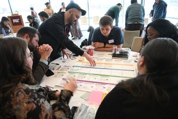 Living Climate Futures Symposium participants worked together to identify potential pros, cons, and trade-offs of allowing a data center to be built in a fictitious community. 