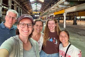 Sara Jex MCP ’25 (second from left) and family members visit 7000 Central Ave. in Cleveland, Ohio, a vacant 183,000-square-foot factory once used to manufacture Hulett unloaders. The building is among the first strategic acquisitions of the Site Readiness Fund for Good Jobs, which is working to redevelop disinvested industrial sites.