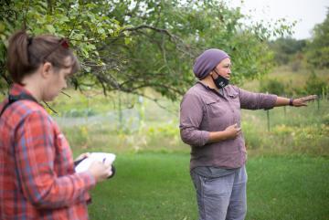 
              ESI Journalism Fellow Nora Hertel (left) takes notes during a tour with Jessika Greendeer, seedkeeper and farm manager for Dream of Wild Health, a Native American-led nonprofit with a farm just outside the Twin Cities in Hugo...