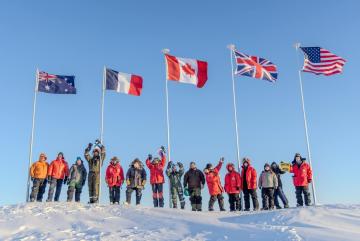 Scientists participating in Operation Ice Camp 2024 display flags representing their countries. 