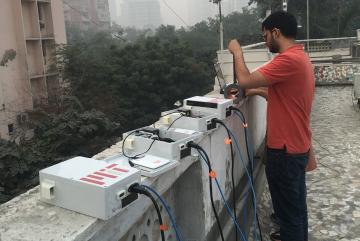 Graduate student Sidhant Pai repairs low-cost air quality sensors near Connaught Place in Central Delhi.Photo: David Hagan 